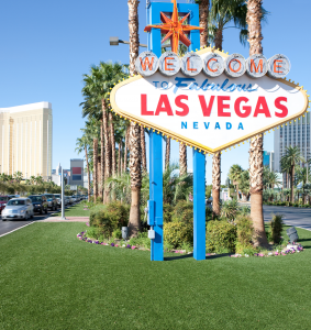 The iconic "Welcome to Fabulous Las Vegas" neon sign under a clear sky, representing the central hub for global trade shows and conventions.