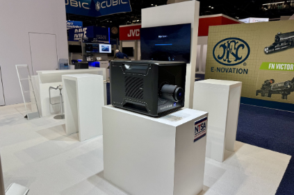 Integrated glass display case at the ZEISS booth showcasing precision lenses and simulation hardware, illuminated with clean LED accent lighting for a laboratory-grade aesthetic.