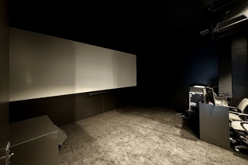 An interactive technology black hub within the ZEISS exhibit designed for technical demonstrations of simulation and training optics, featuring sleek white cabinetry and high-resolution monitors.